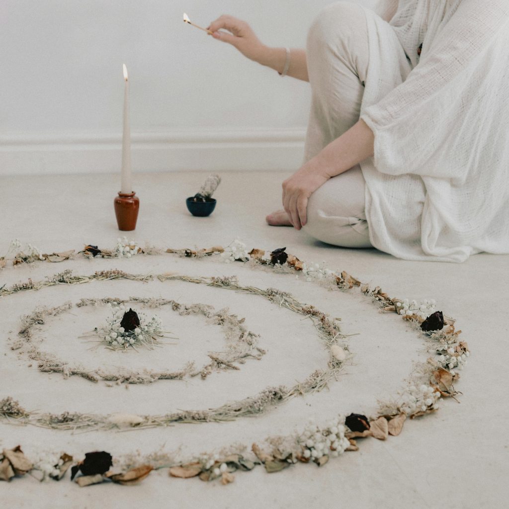 pexels photo 31371631 31371631 A serene meditation space with a candle-lit dried floral mandala on the floor.